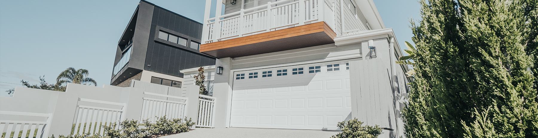 Heritage sectional garage door in Colorbond® Surfmist® with Stockton windows.