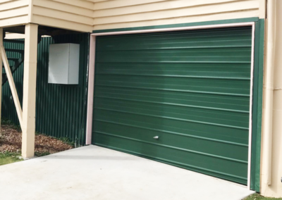 A forest green coloured garage door