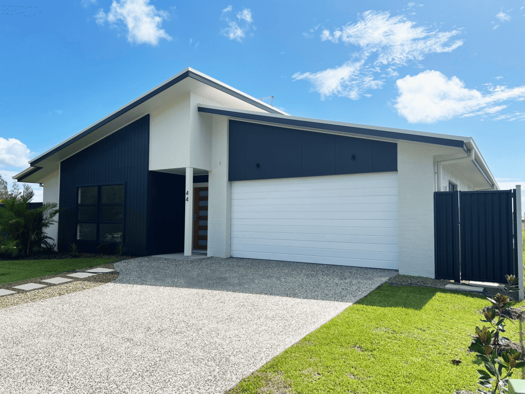 modern suburban home with white automatic garage door